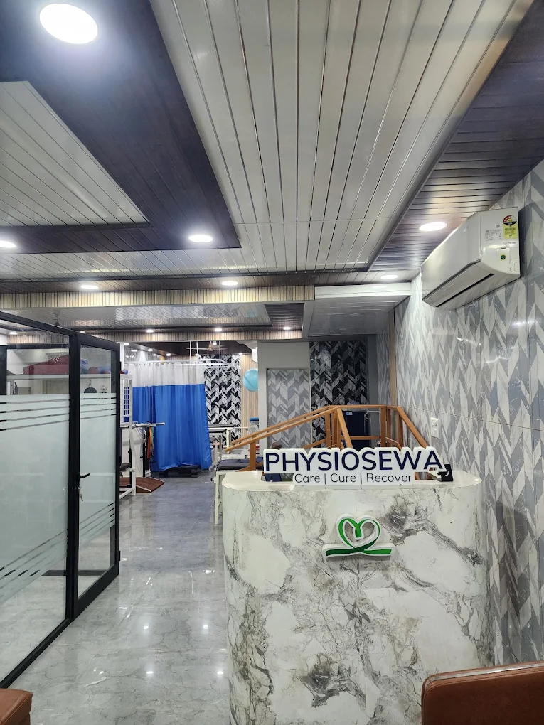 PhysioSewa reception desk with Care Cure Recover branding